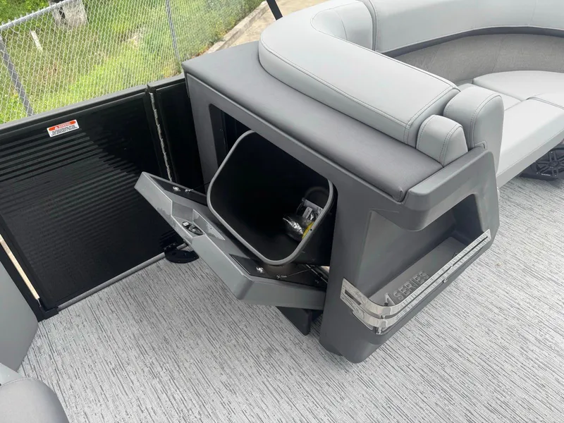 Slide: The Image of 2025 Bennington 22MFB boat interior with open storage compartment and seating. - 12