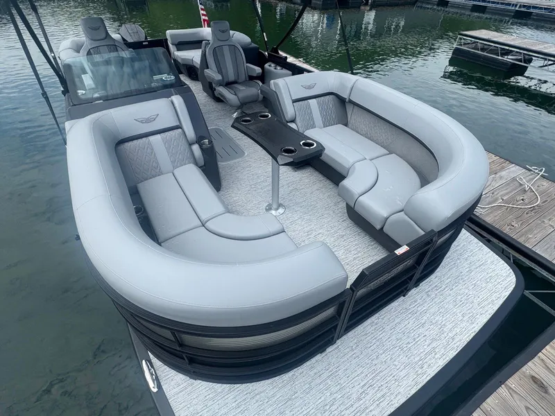 Slide: The Image of 2025 Bennington 22MFB pontoon boat with luxurious seating on a calm lake. - 16