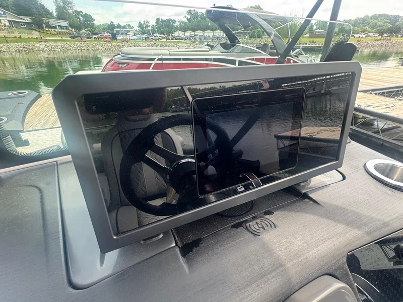 Slide: The Image of Dashboard of a 2025 Bennington 22MFB boat with steering wheel and touchscreen display. - 22