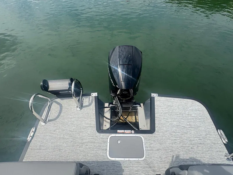 Slide: The Image of 2025 Bennington 22MFB boat with outboard motor on calm water. - 23