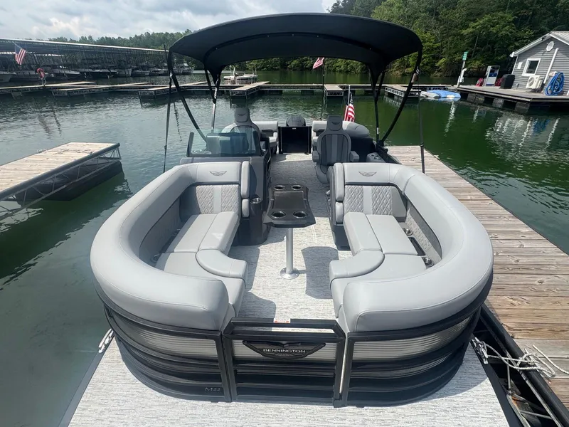 Slide: The Image of 2025 Bennington 22MFB pontoon boat docked, featuring spacious seating and canopy. - 29