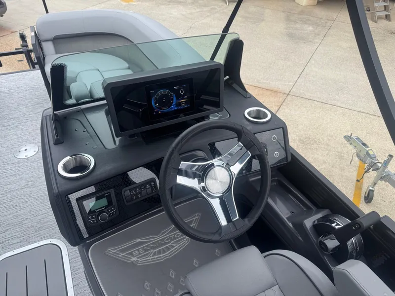Slide: The Image of 2025 Bennington 22MFB boat dashboard with steering wheel and digital display. - 8