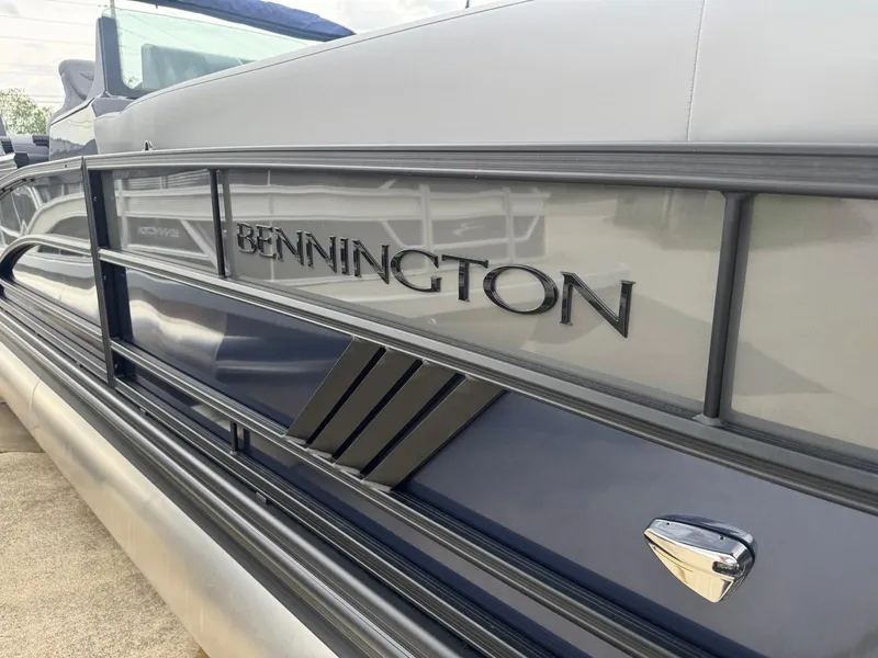 Slide: The Image of 2025 Bennington 24MFB pontoon boat, sleek design with metallic accents. - 12