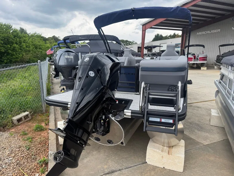 Slide: The Image of 2025 Bennington 24MFB pontoon boat with Yamaha outboard motor, docked outdoors. - 13