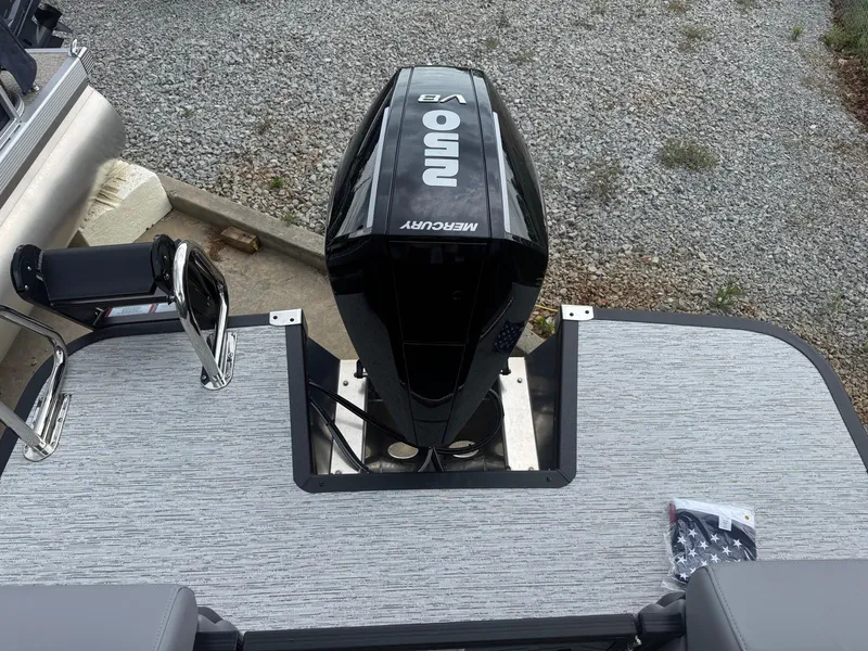 Slide: The Image of 2025 Bennington 24MFB boat with Mercury V8 engine on a textured deck. - 7