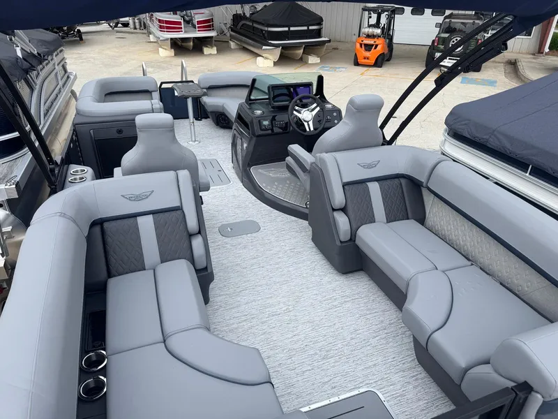 Slide: The Image of 2025 Bennington 24MFB pontoon boat interior with luxurious gray seating and modern dashboard. - 8