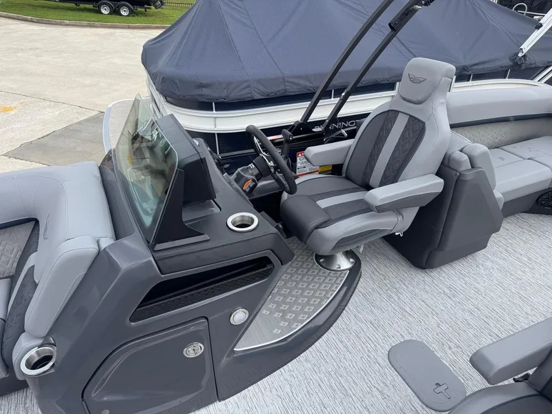 Slide: The Image of 2025 Bennington 24MFB boat interior with modern helm and luxurious seating. - 9