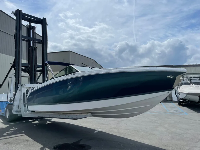 Slide: The Image of 2022 Cobalt R8 boat lifted by forklift in marina setting. - 3