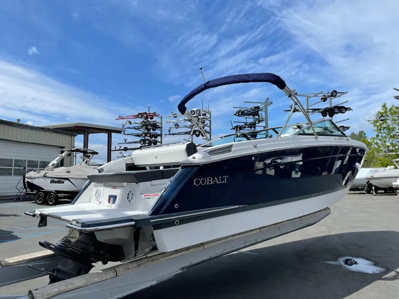 Slide: The Image of 2022 Cobalt R8 boat on trailer, displayed outdoors under a clear blue sky. - 4