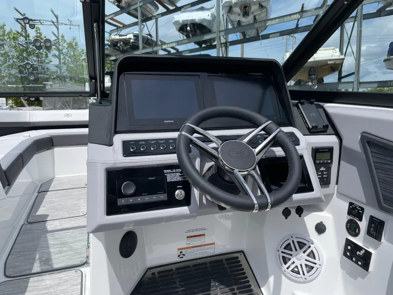 Slide: The Image of 2022 Cobalt R8 boat dashboard with steering wheel and navigation screens. - 6