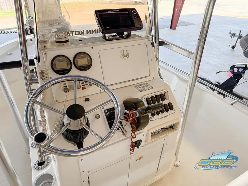 Slide: The Image of 2004 NauticStar 1900 Nautic Bay boat console with steering wheel and controls. - 13