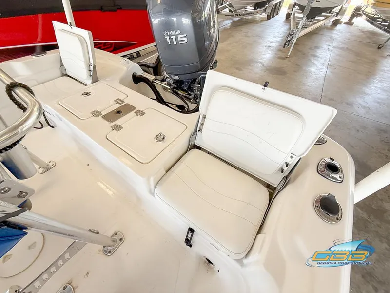 Slide: The Image of 2004 NauticStar 1900 Nautic Bay boat interior with Yamaha 115 engine, white seating, and storage. - 26