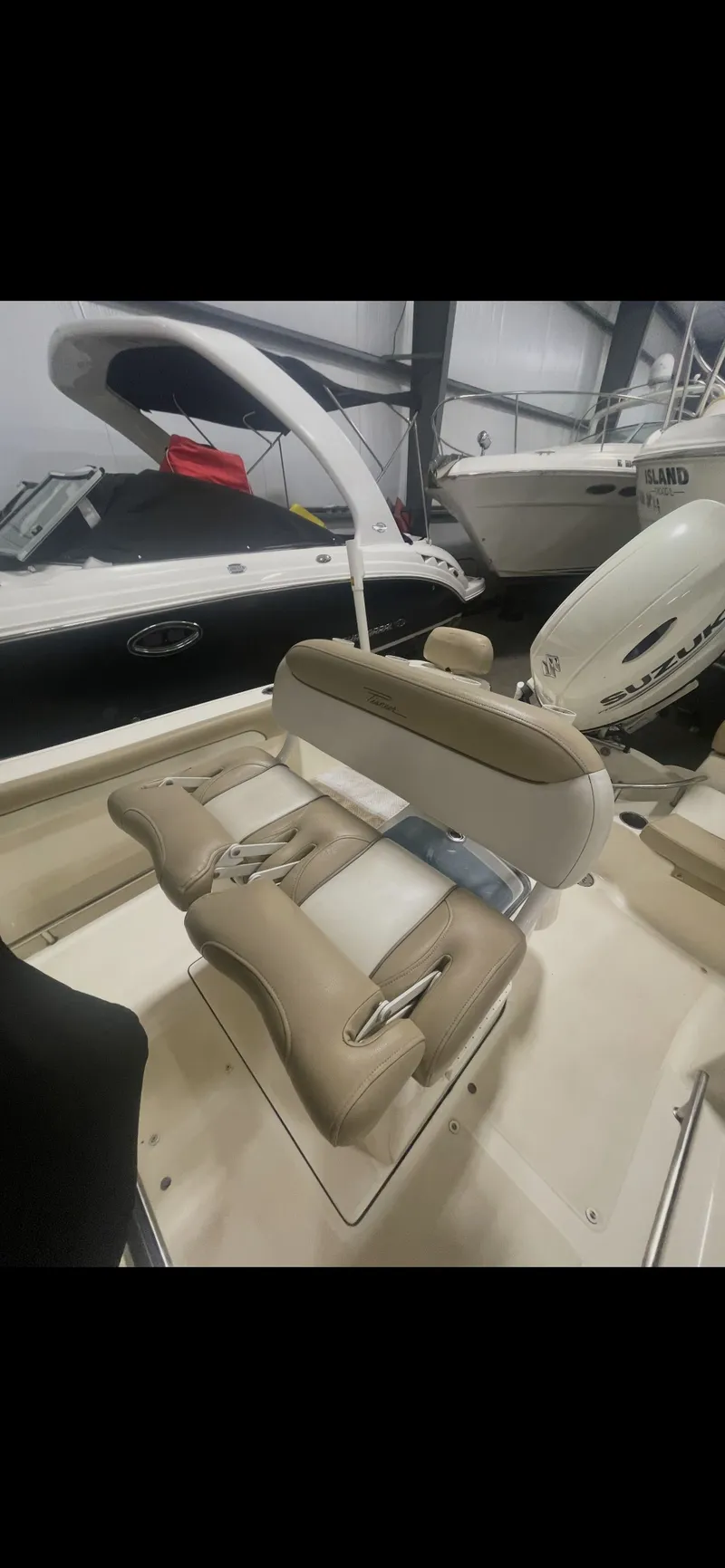 Slide: The Image of 2019 Pioneer 202 Sportfish boat with beige interior seating. - 6