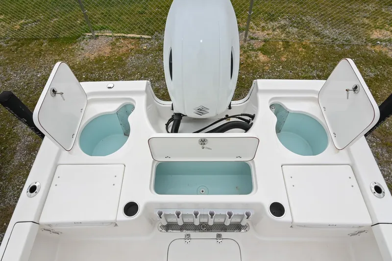 Slide: The Image of 2021 Sea Pro 208 Bay boat with open storage compartments and motor, viewed from above. - 12