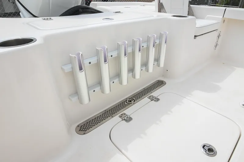 Slide: The Image of 2021 Sea Pro 208 Bay boat interior with rod holders and storage compartments. - 17