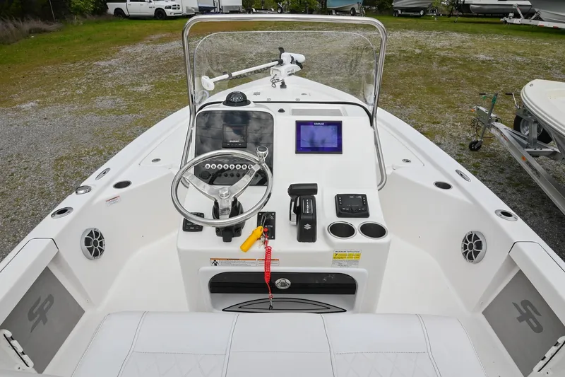 Slide: The Image of 2021 Sea Pro 208 Bay boat dashboard with steering wheel and navigation controls. - 23