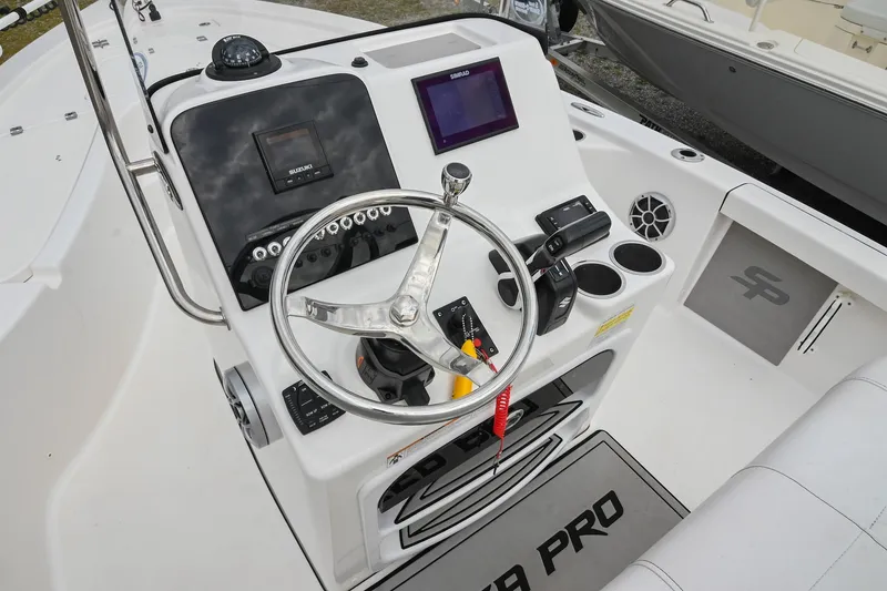Slide: The Image of 2021 Sea Pro 208 Bay boat dashboard with steering wheel and electronic controls. - 24