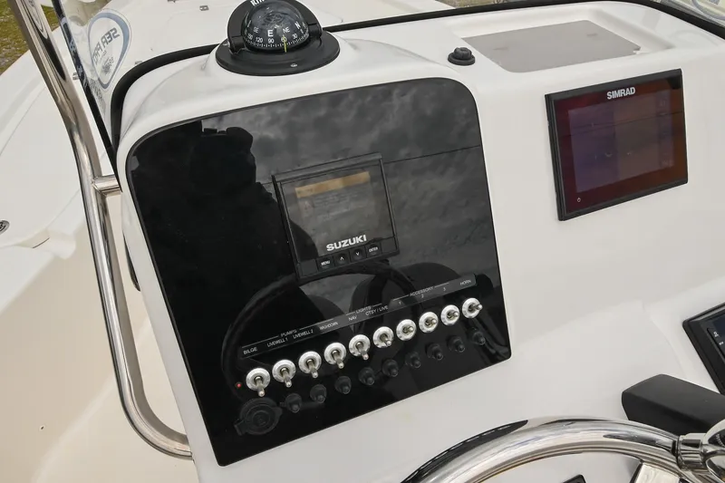 Slide: The Image of 2021 Sea Pro 208 Bay boat dashboard with Suzuki controls and Simrad display. - 25
