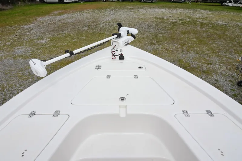 Slide: The Image of 2021 Sea Pro 208 Bay boat deck with trolling motor, parked on gravel. - 33