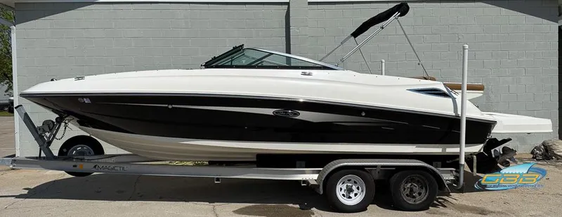 The Image of 2015 Sea Ray 240 Sundeck boat on trailer, side view, black and white design. - 0