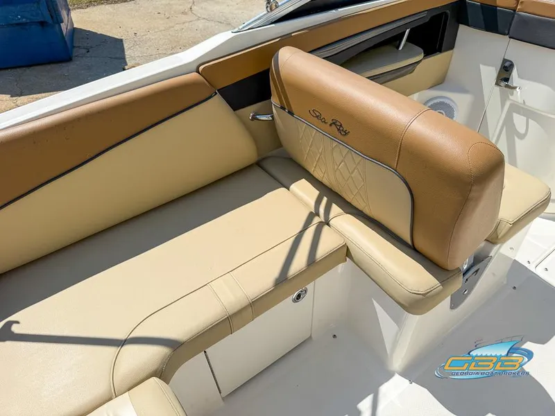 Slide: The Image of 2015 Sea Ray 240 Sundeck interior with tan leather seating and storage compartment. - 11