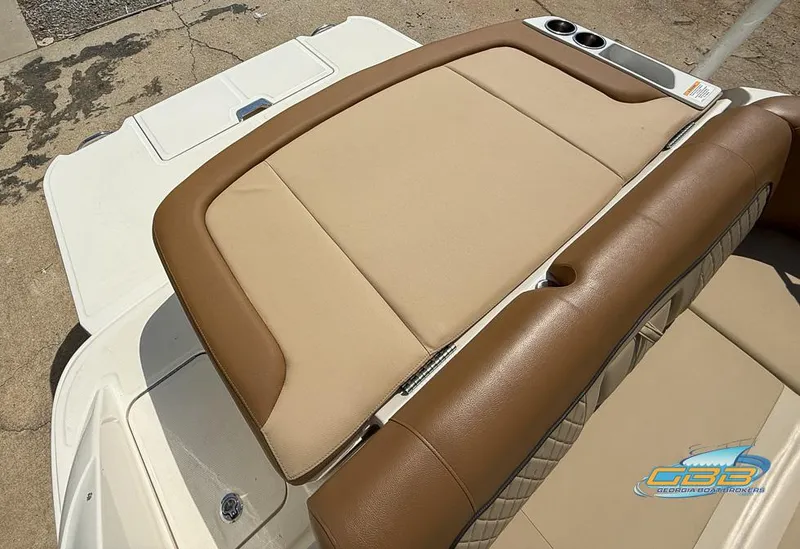 Slide: The Image of 2015 Sea Ray 240 Sundeck boat with tan leather seating and cup holders. - 14