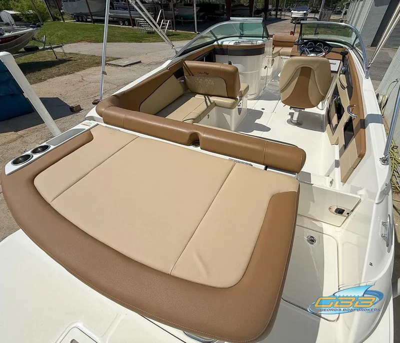 Slide: The Image of 2015 Sea Ray 240 Sundeck boat interior with tan seating and modern dashboard. - 15