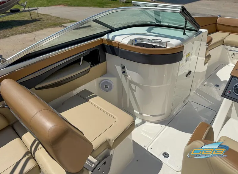 Slide: The Image of 2015 Sea Ray 240 Sundeck interior with beige seating and sleek dashboard design. - 17