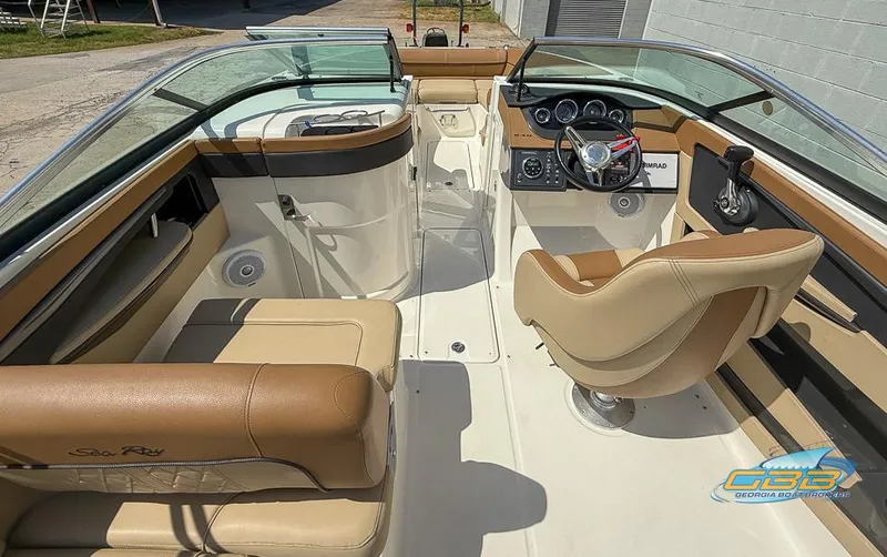 Slide: The Image of 2015 Sea Ray 240 Sundeck interior with tan seating and modern dashboard. - 18