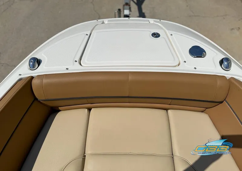 Slide: The Image of 2015 Sea Ray 240 Sundeck boat with tan seating and white deck. - 24