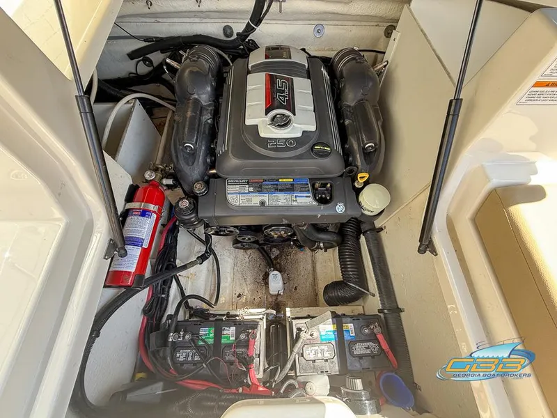 Slide: The Image of Engine compartment of a 2015 Sea Ray 240 Sundeck with visible components and fire extinguisher. - 25