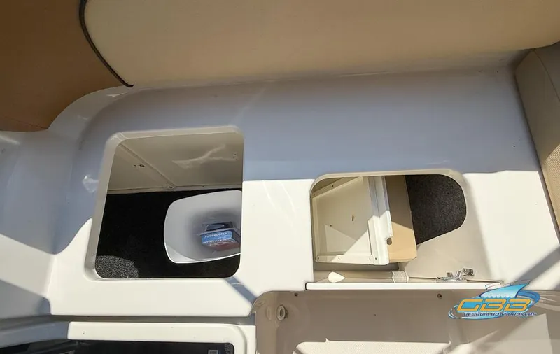Slide: The Image of 2015 Sea Ray 240 Sundeck storage compartments with open hatches, showcasing interior space. - 29