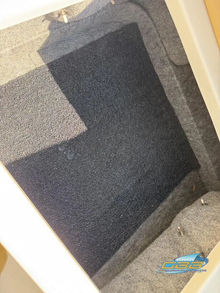 Slide: The Image of 2015 Sea Ray 240 Sundeck storage compartment with carpeted interior. - 31