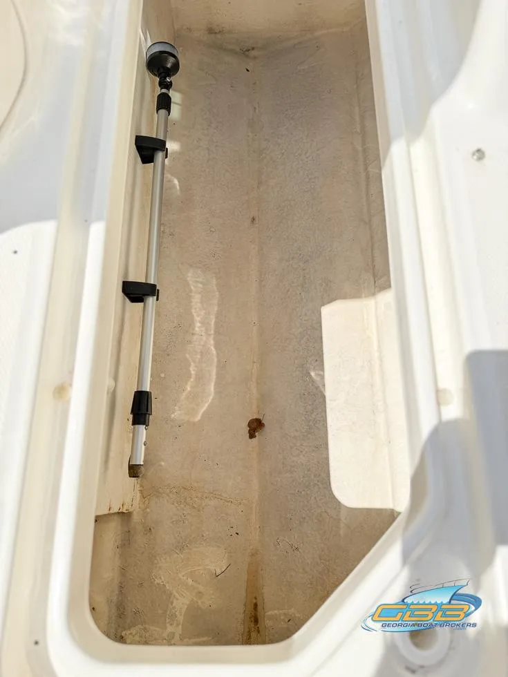 Slide: The Image of Storage compartment of 2015 Sea Ray 240 Sundeck boat, featuring a telescopic pole. - 32