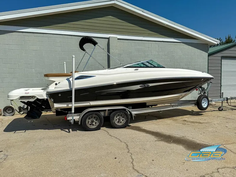 Slide: The Image of 2015 Sea Ray 240 Sundeck boat on trailer, parked outdoors. - 5