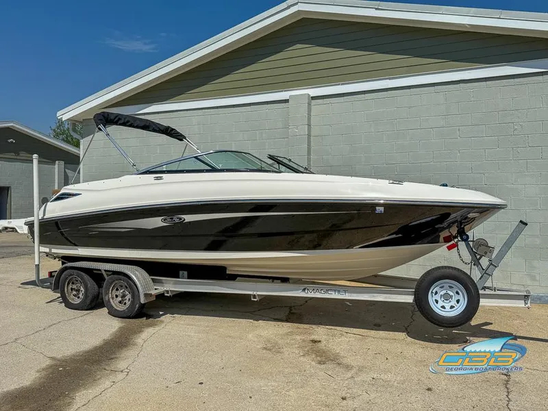 Slide: The Image of 2015 Sea Ray 240 Sundeck boat on trailer, parked outdoors. - 6