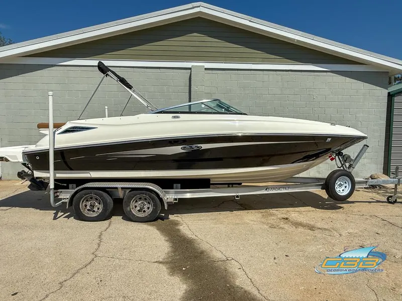 Slide: The Image of 2015 Sea Ray 240 Sundeck boat on trailer, parked outdoors. - 7