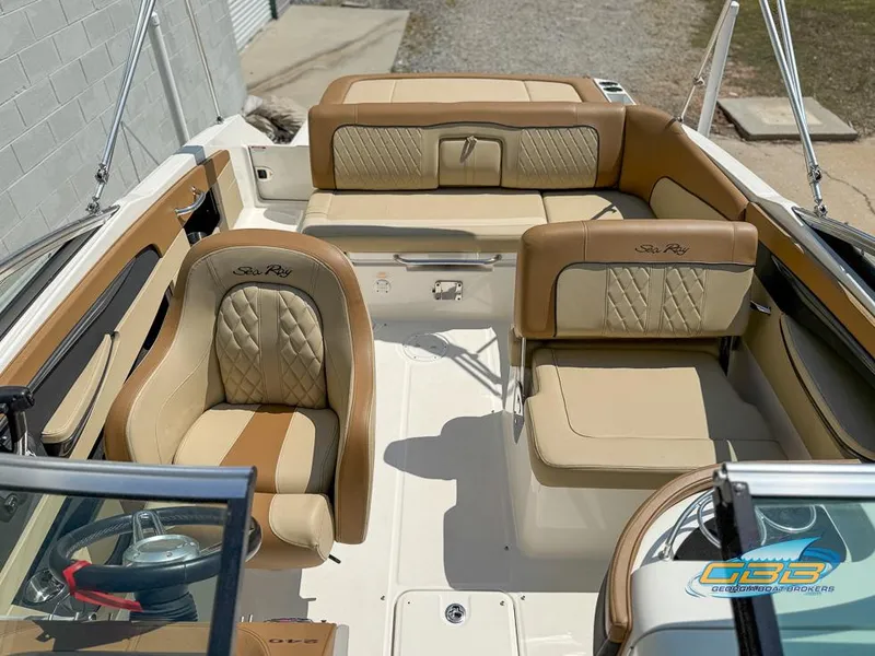 Slide: The Image of 2015 Sea Ray 240 Sundeck interior with beige leather seating and elegant design. - 9
