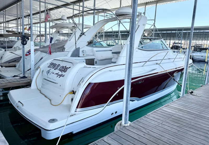 Slide: The Image of 2007 Formula 34 Cruiser docked in marina, featuring sleek white and red design. - 7