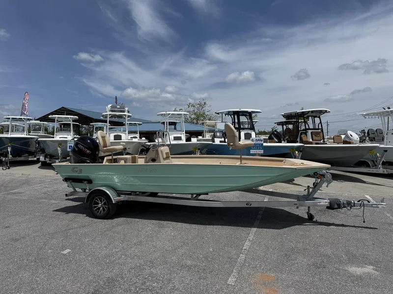 Slide: The Image of 2025 G3 Bay 20 Seadeck boat on trailer, displayed at dealership under cloudy sky. - 1