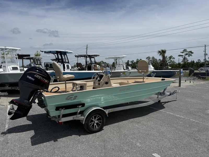 Slide: The Image of 2025 G3 Bay 20 Seadeck boat with Yamaha engine on trailer in parking lot. - 2