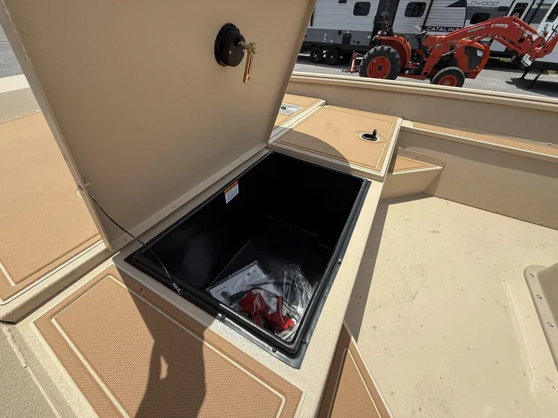 Slide: The Image of Open storage compartment on 2025 G3 Bay 20 Seadeck boat, with visible contents. - 7