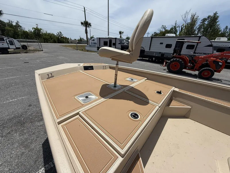 Slide: The Image of 2025 G3 Bay 20 Seadeck boat with elevated seat, parked near trailers and tractor. - 8