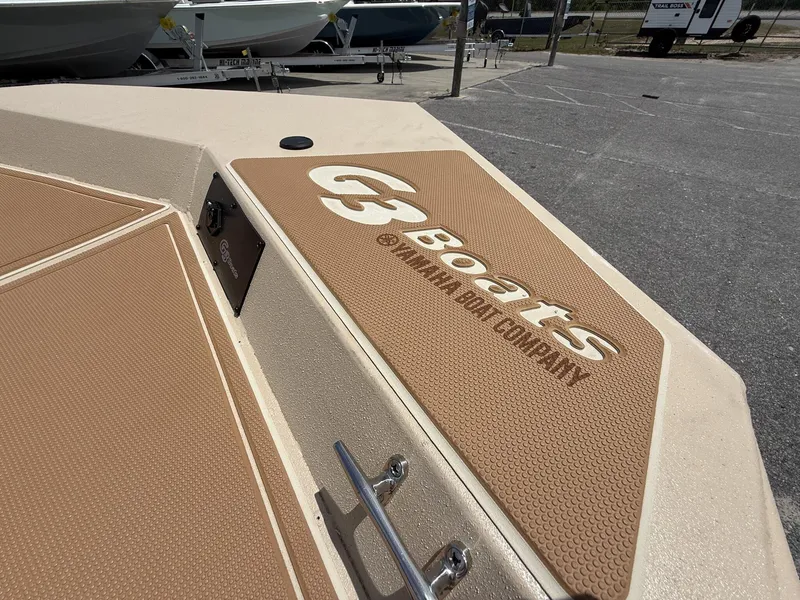 Slide: The Image of 2025 G3 Bay 20 Seadeck boat with tan non-slip surface in a parking lot. - 9