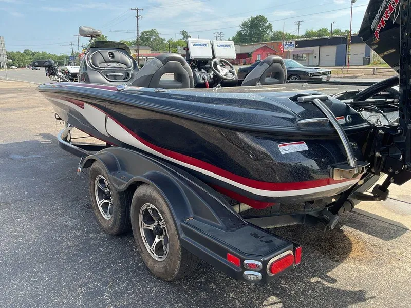 Slide: The Image of 2015 Nitro Z9 DC Z-PRO boat on trailer, parked outdoors, featuring sleek black and red design. - 26