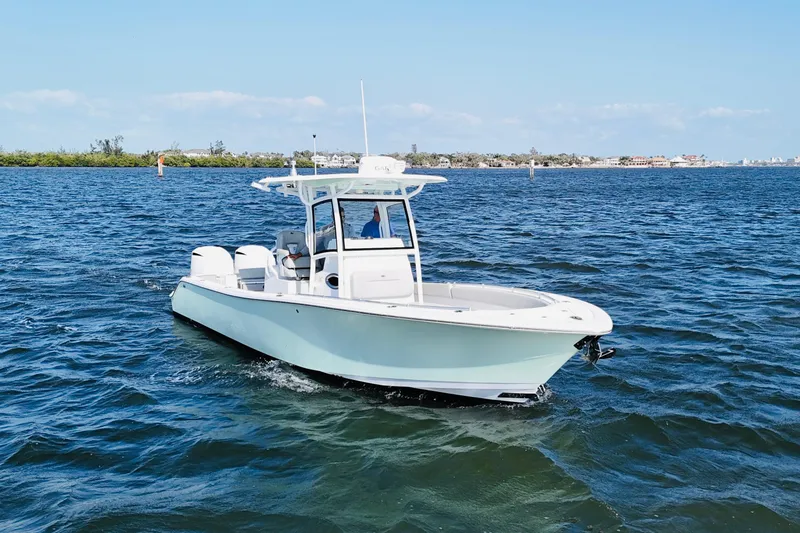 Slide: The Image of 2020 Sportsman Open 282 Center Console boat cruising on open water. - 10