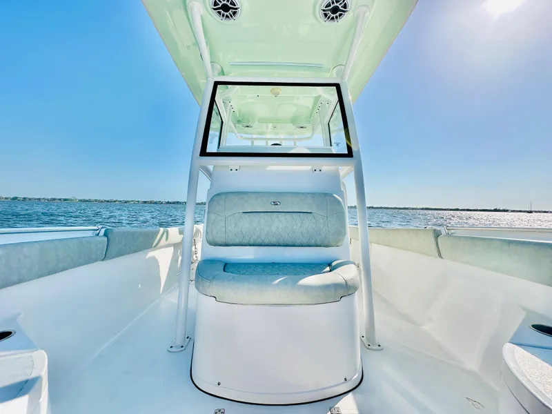 Slide: The Image of 2020 Sportsman Open 282 Center Console boat on water, featuring sleek seating and modern design. - 14