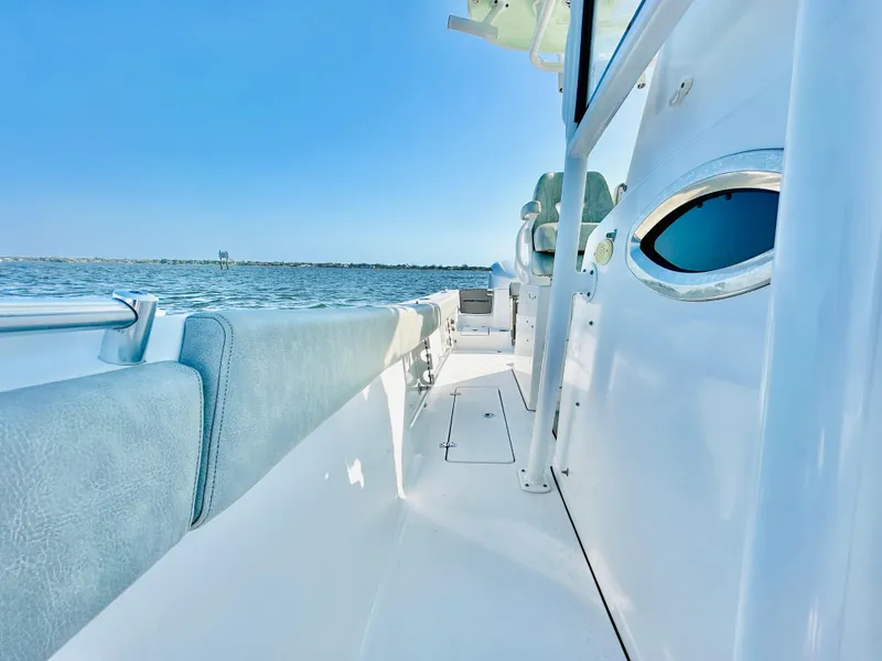 Slide: The Image of 2020 Sportsman Open 282 Center Console boat on calm water, clear sky. - 18