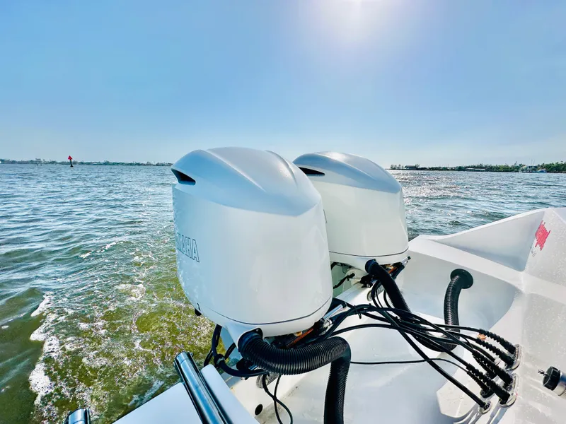 Slide: The Image of 2020 Sportsman Open 282 Center Console with dual outboard motors on open water. - 21