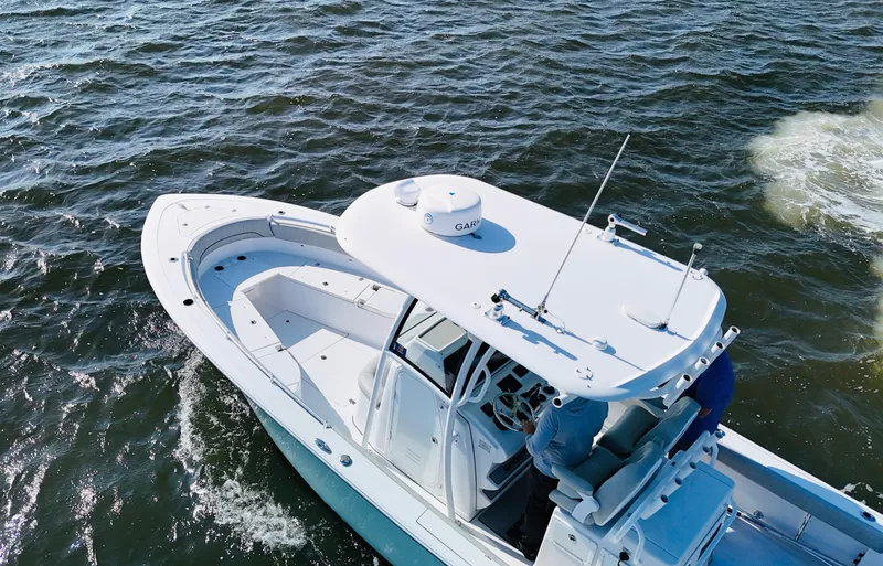Slide: The Image of 2020 Sportsman Open 282 Center Console boat cruising on open water. - 6
